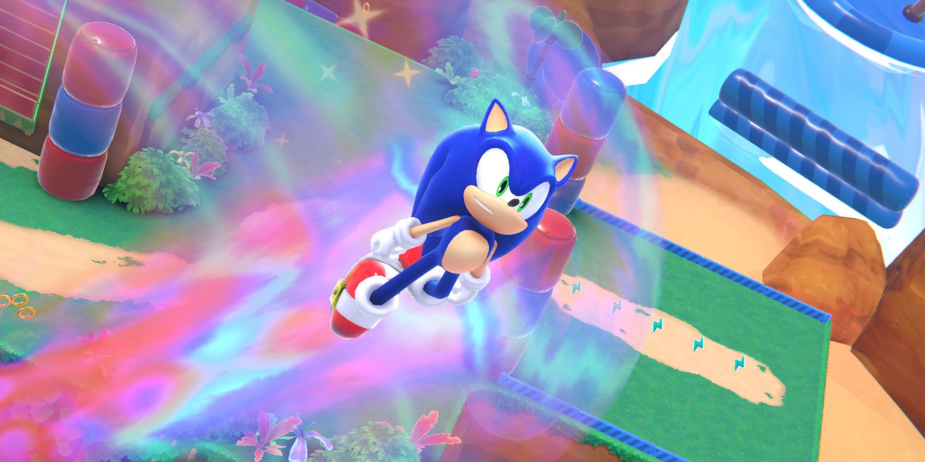 A screenshot of Sonic the Hedgehog blasting through the air above a colorful dream world in Sonic Dream Team.