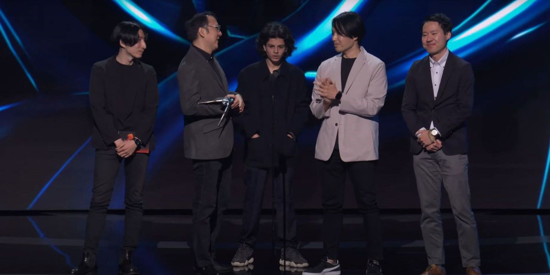 the game awards crasher matan evan on stage with elden ring developers before speaking in 2022