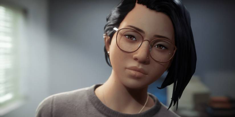 Alex, a girl with glasses and a nose stud, looks solemnly forward