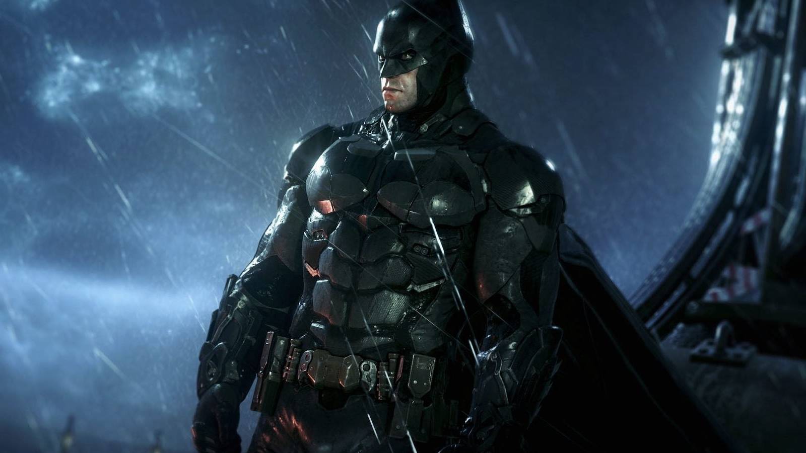 A screenshot of Batman overlooking Gotham from a rainy rooftop with his bat ears cropped out in Batman: Arkham Knight.