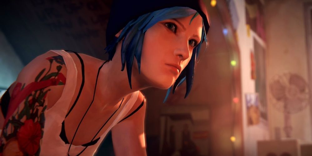 Chloe, a teenage girl with bright blue hair and tattoos, looking at someone off screen angrily