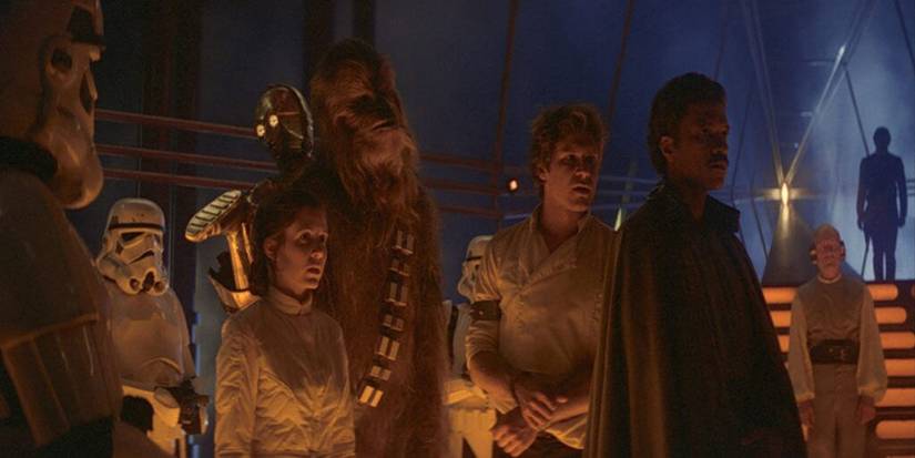 Han, Lando, Leia, Chewbacca, and C-3PO stand in the carbon freezing chamber