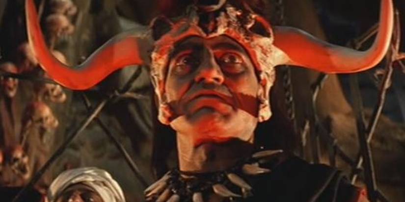 The evil priest from Temple of Doom with his sacrifice victim behind him