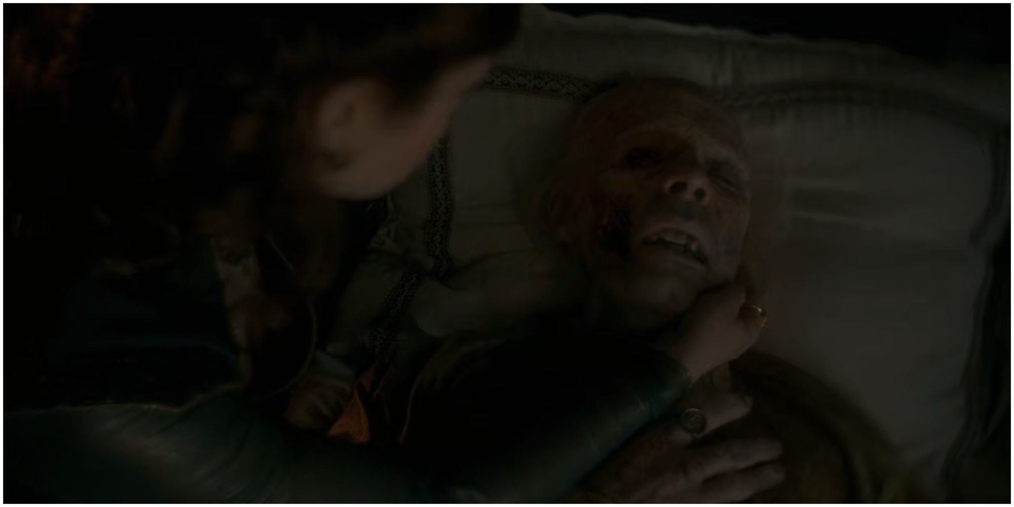 Alicent Hightower watches as Viserys Targaryen dies in House of the Dragon.