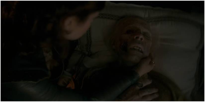 Alicent Hightower watches as Viserys Targaryen dies in House of the Dragon.