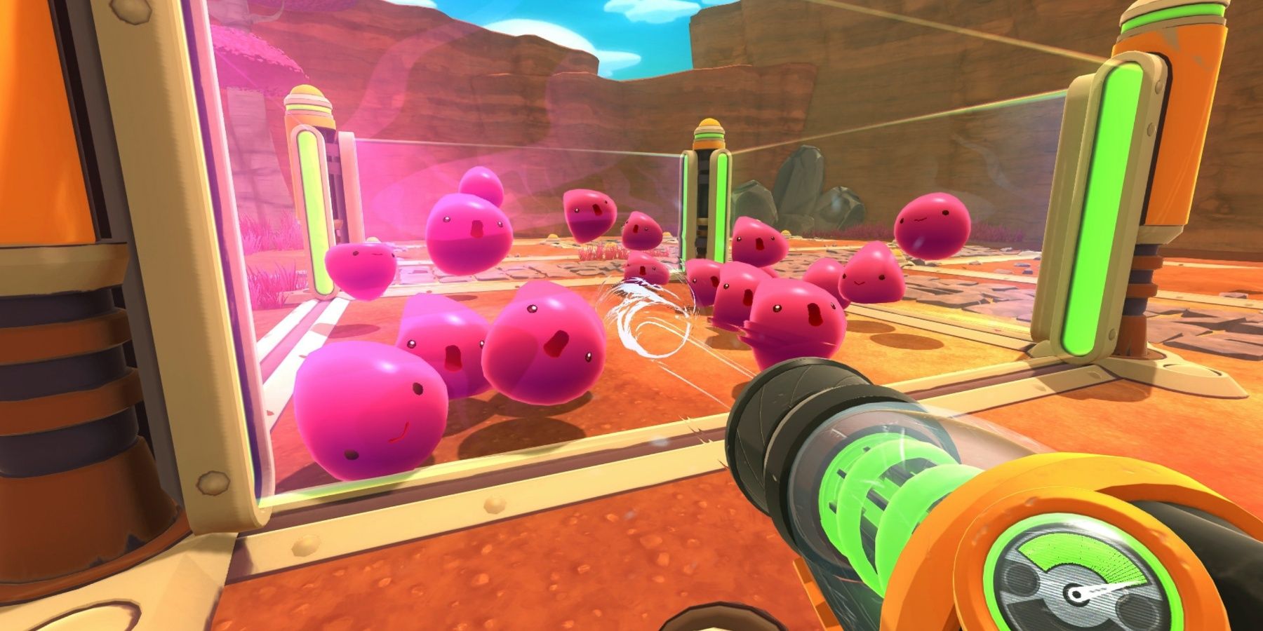 Pink Slimes from Slime Rancher 1 in a see through cage as the player looks at them