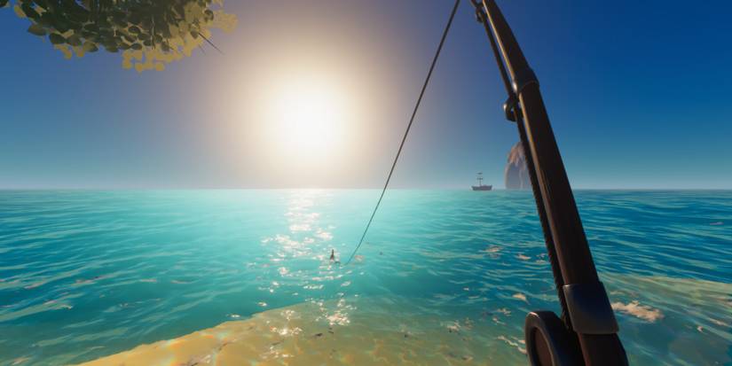 The player fishing in a light blue ocean as the sun begins to set. A pirate ship is sailing in the background.