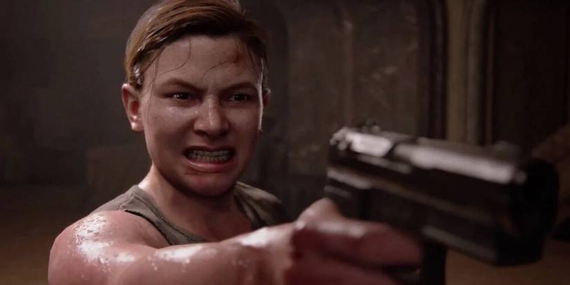 Abby aiming a handgun 