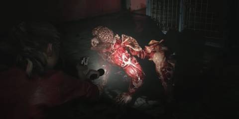 Claire aiming a flashlight at a licker 