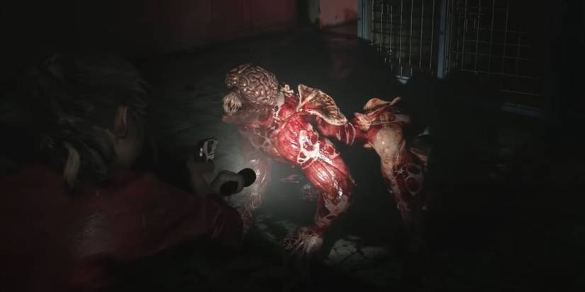 Claire aiming a flashlight at a licker 