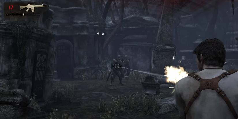 Nathan Drake shooting at a group of enemies 