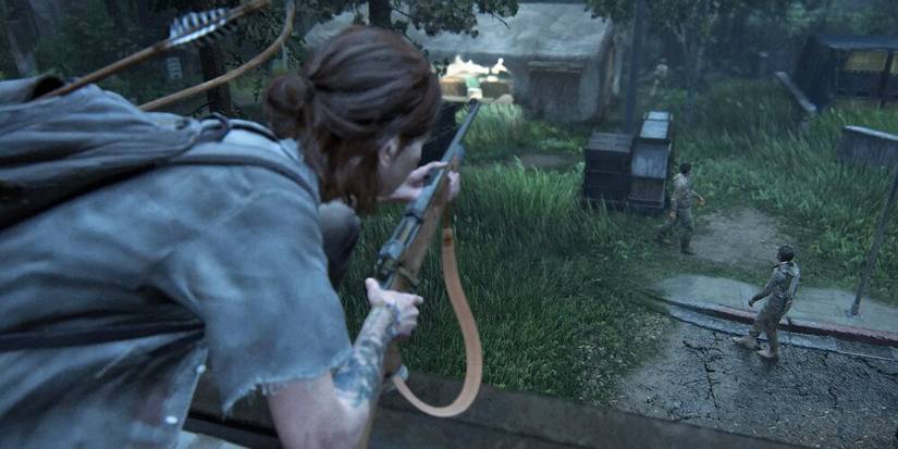 Ellie perching on top of a wall watching an enemy 