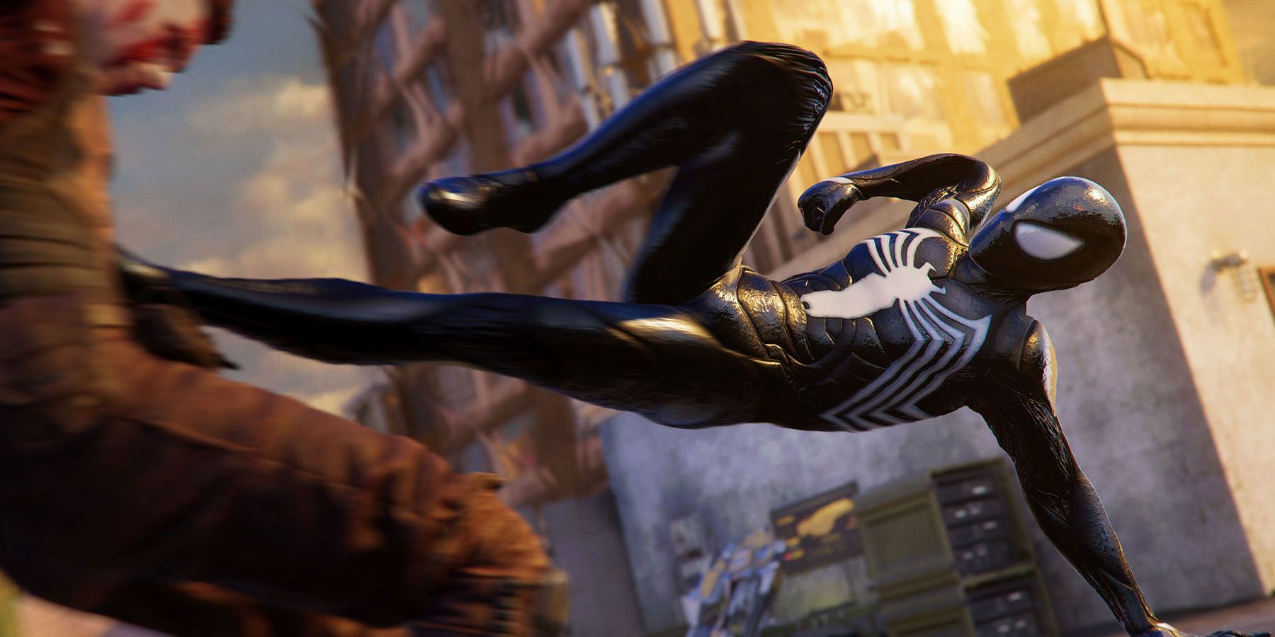 A screenshot of the Black Suit Spider-Man kicking a criminal in Marvel's Spider-Man 2.