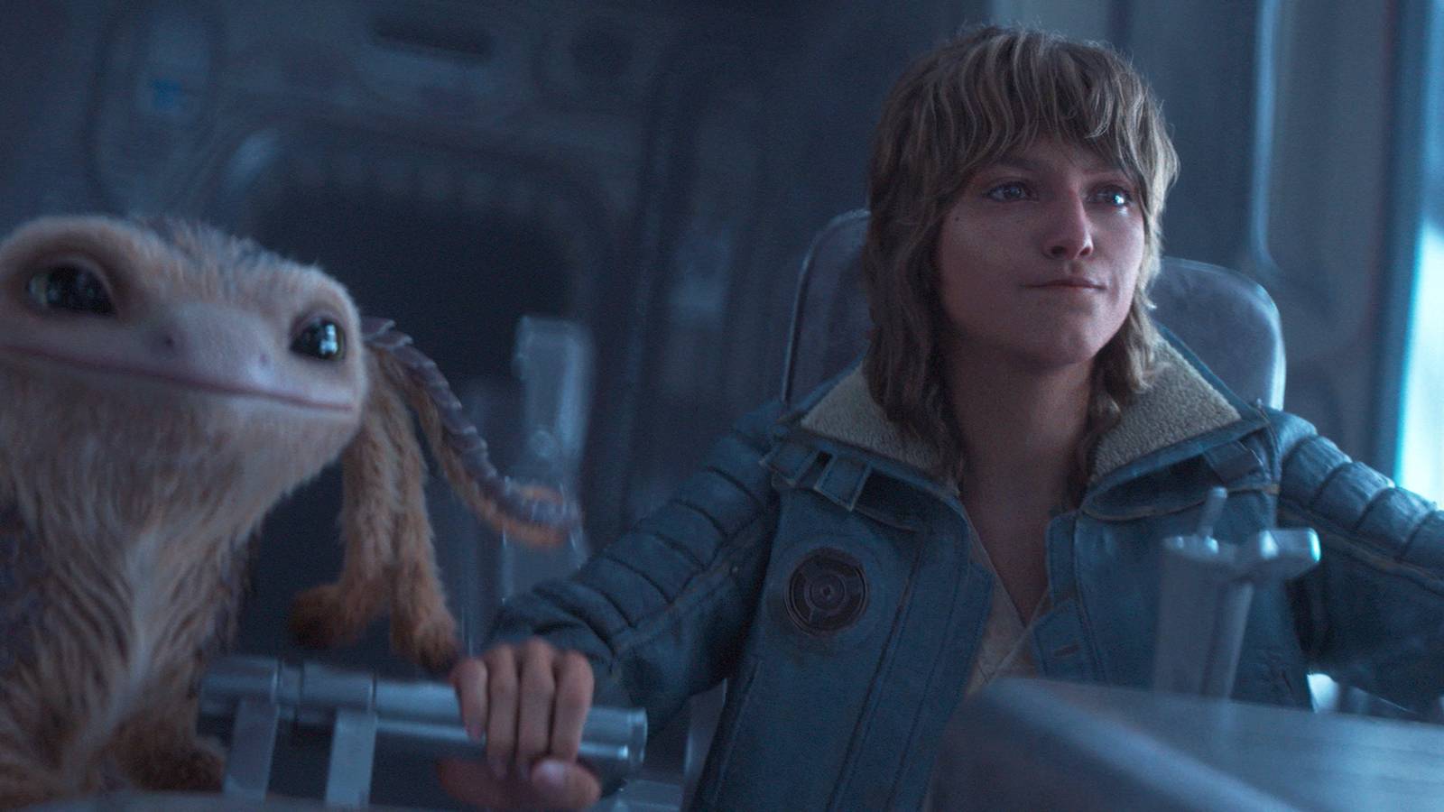 A screenshot of Kay Vess and Nix in the cockpit of thier spaceship in Star Wars Outlaws.