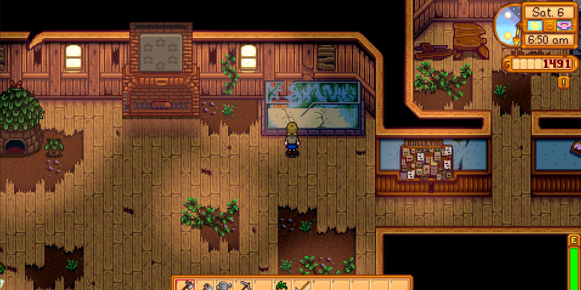 Image of a character standing in front of the fish tank in the Community Center in Stardew Valley