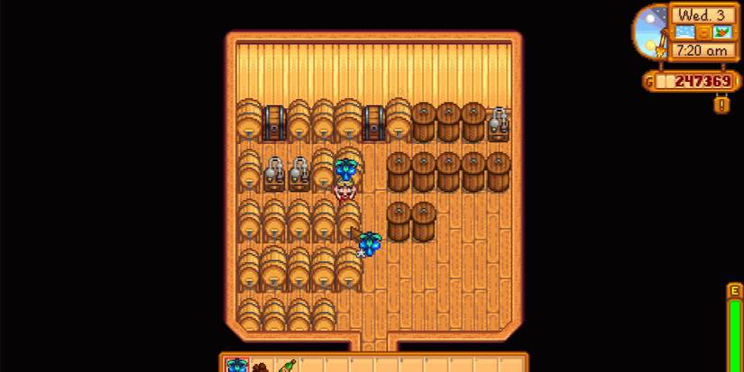 Image of a character placing a Crystal Fruit into a keg in Stardew Valley