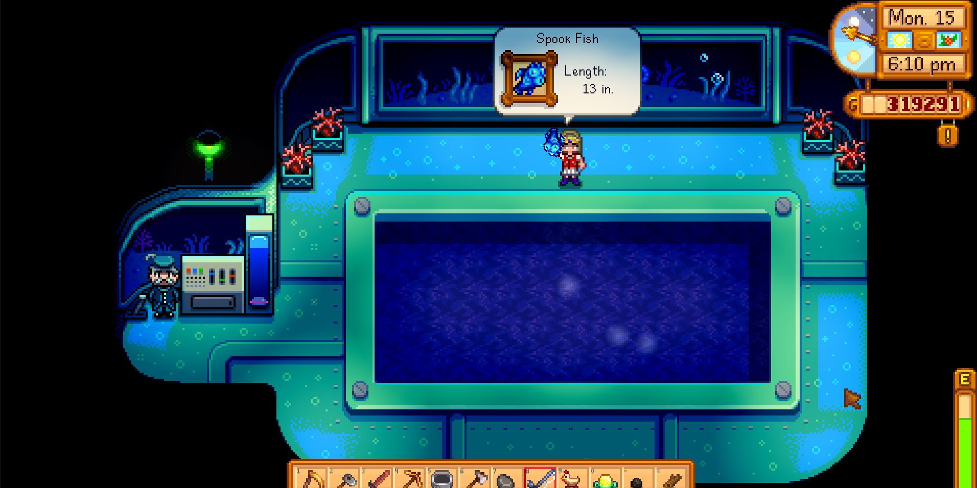 Image of a character catching a Spook Fish in the Night Market submarine in Stardew Valley