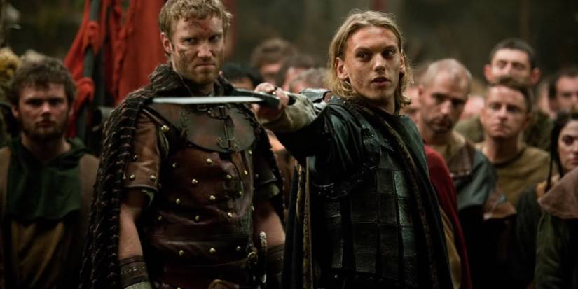 Arthur holding a sword in a crowd