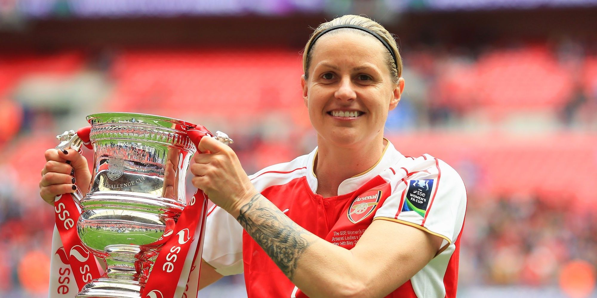 Kelly Smith holding trophy 