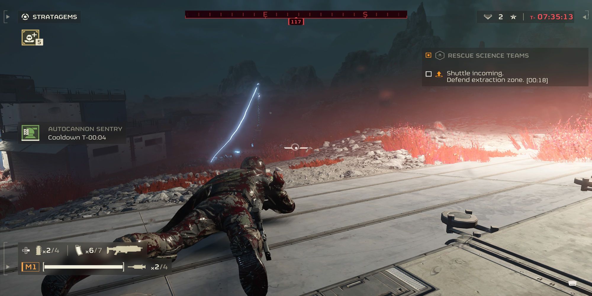 A player is prone in front of a Tesla Tower