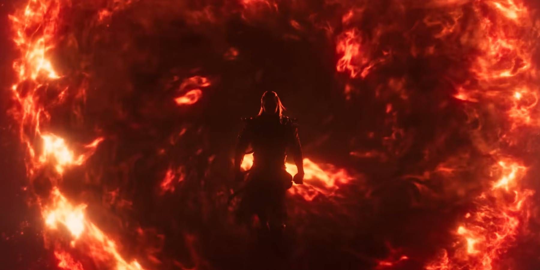 A shadowed Shang Tsung emerging from a flaming portal in Mortal Kombat 1's reveal trailer