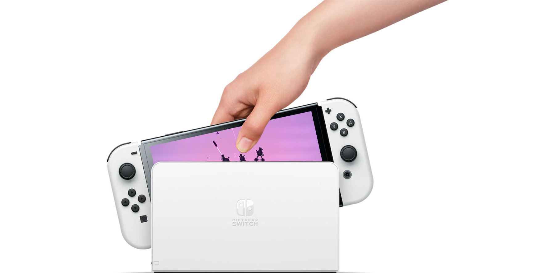 Nintendo Switch OLED Model displaying purple World of Goo 2 announcement trailer screenshot while hand inserts it into dockjpg