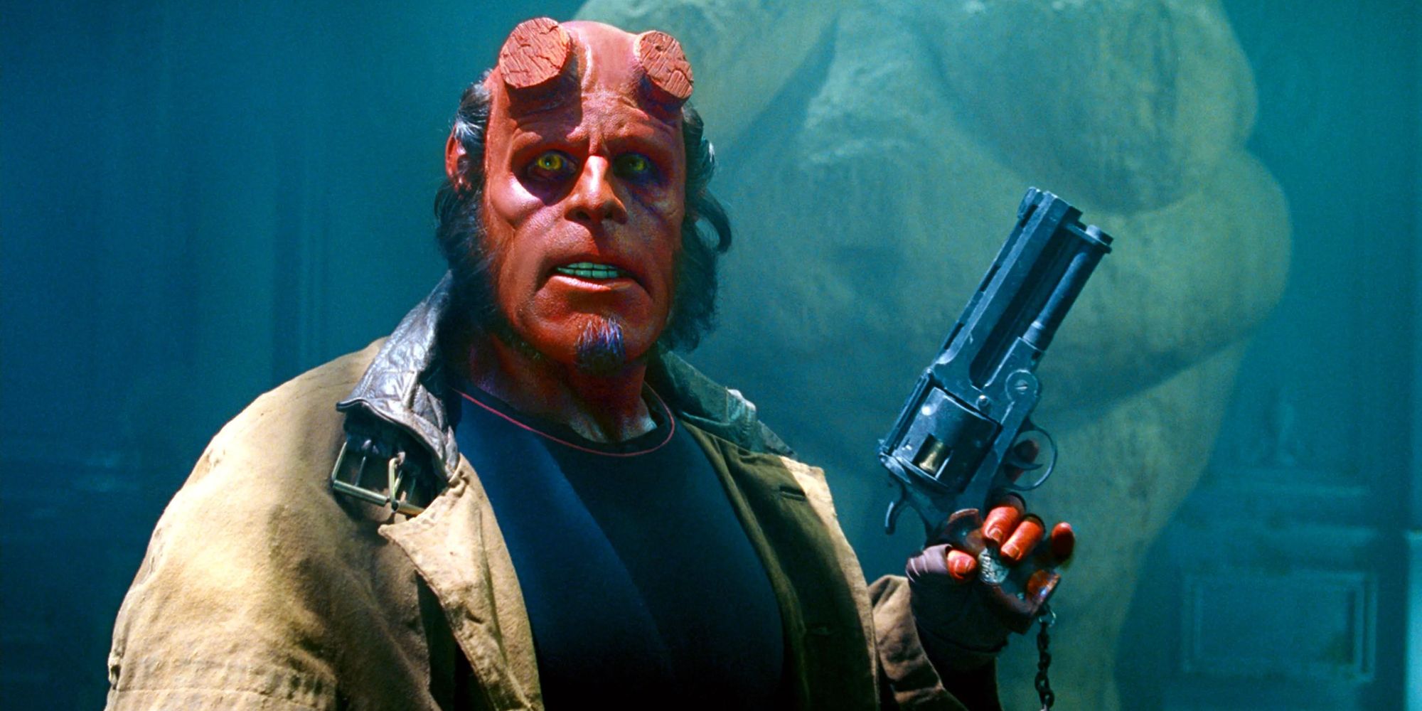 Perlman as Hellboy holding a gun