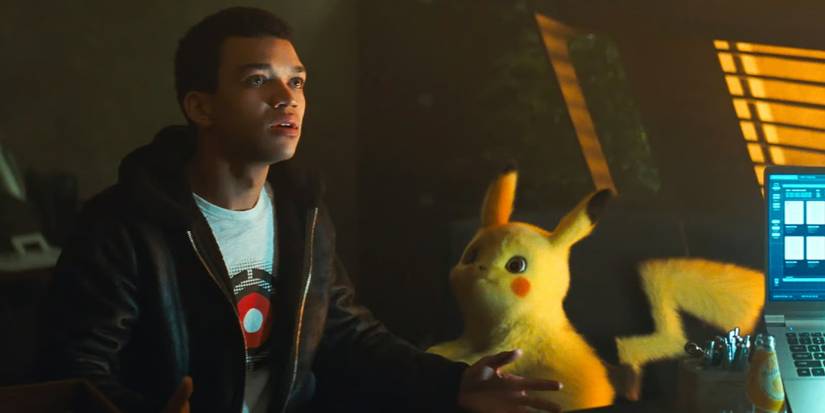 Tim sitting with Pikachu