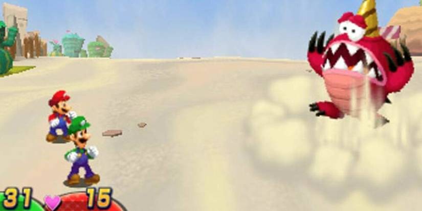 Luigi and Mario battling a red monster in a desert 