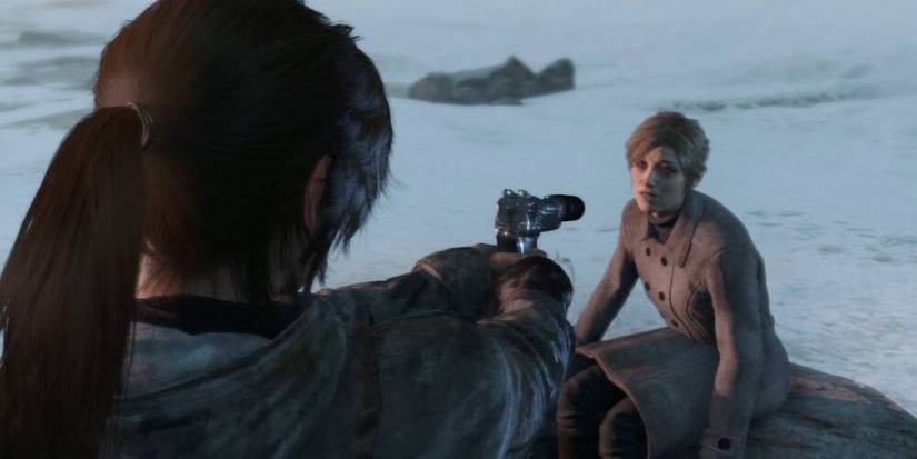 Lara aiming a handgun at Ana 