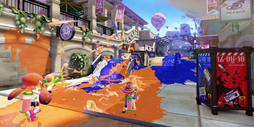 Characters firing ink at one another across a stage 