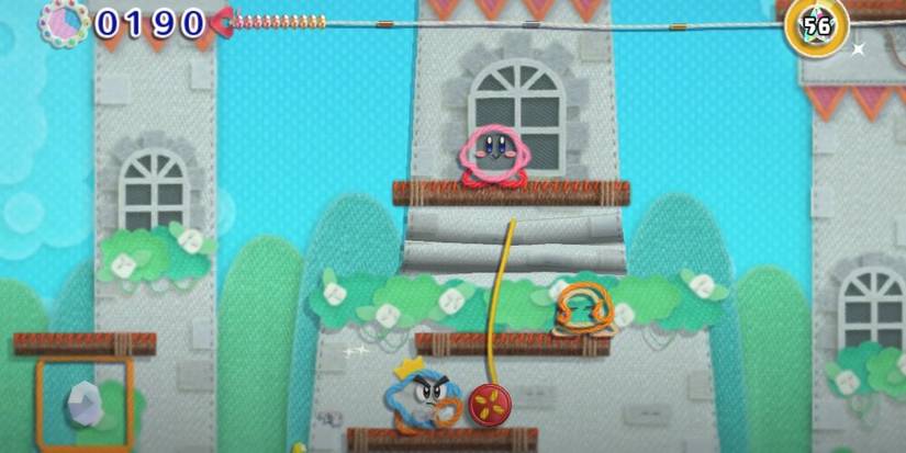 Kirby standing on a platform in a yarn world 