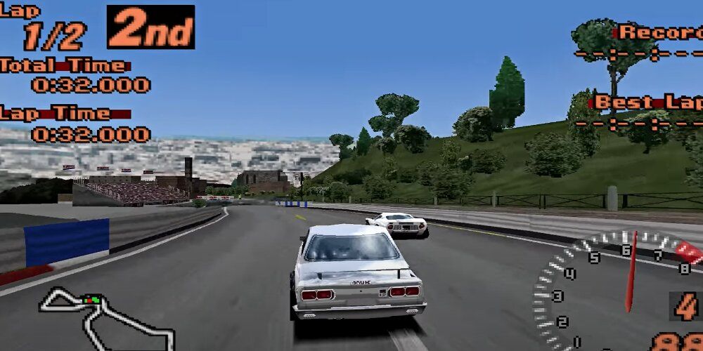 Gray car racing with a large city in the background 