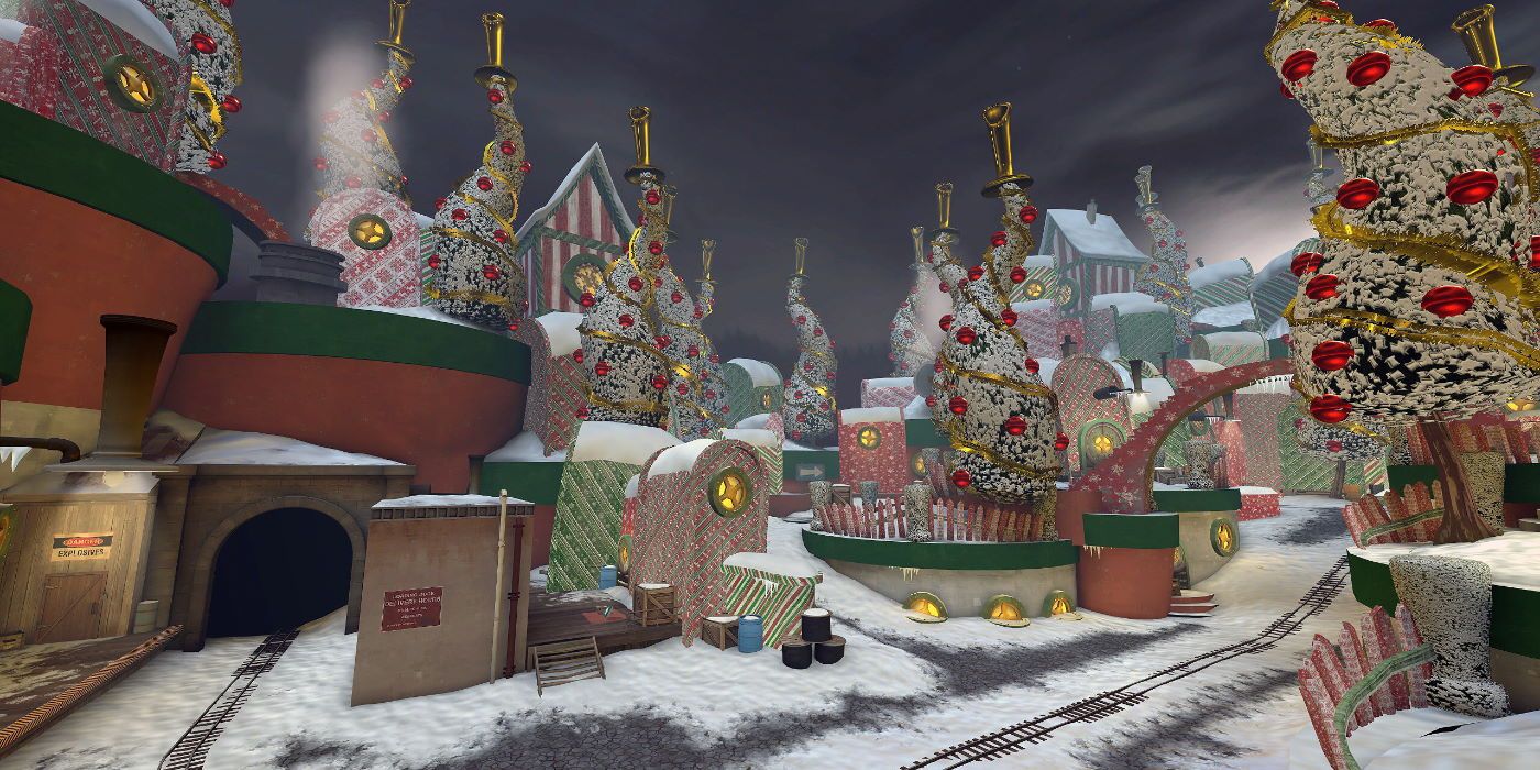 An Xmas village with a train track running through it 