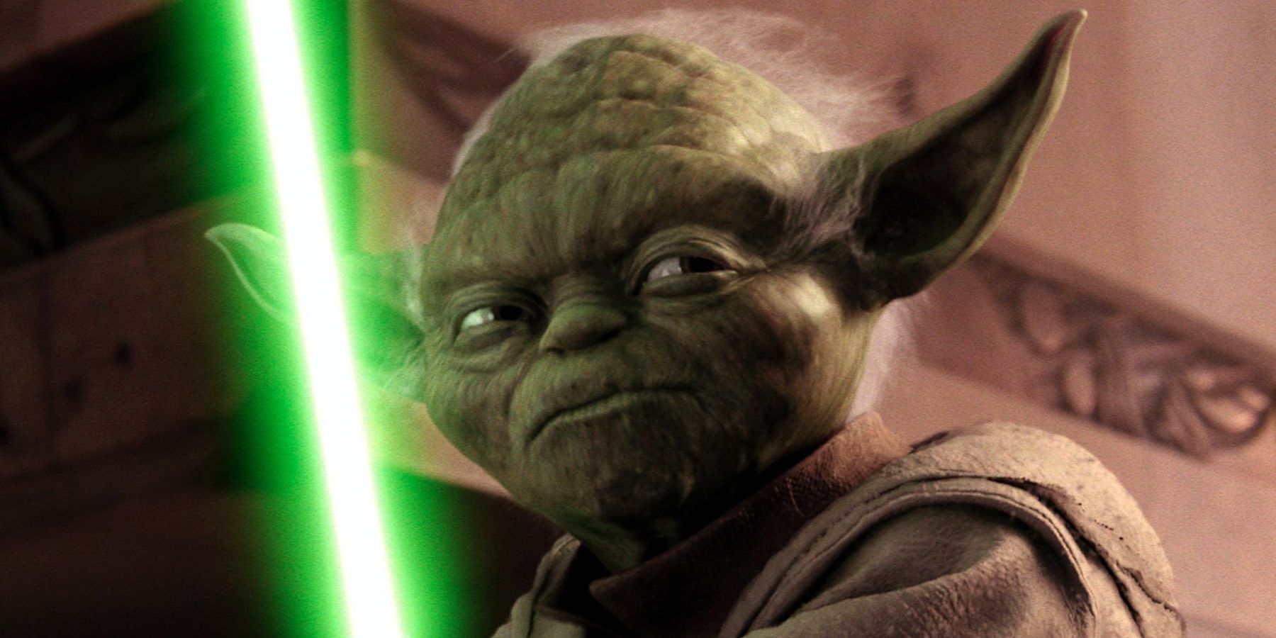 Yoda stands with his green lightsaber
