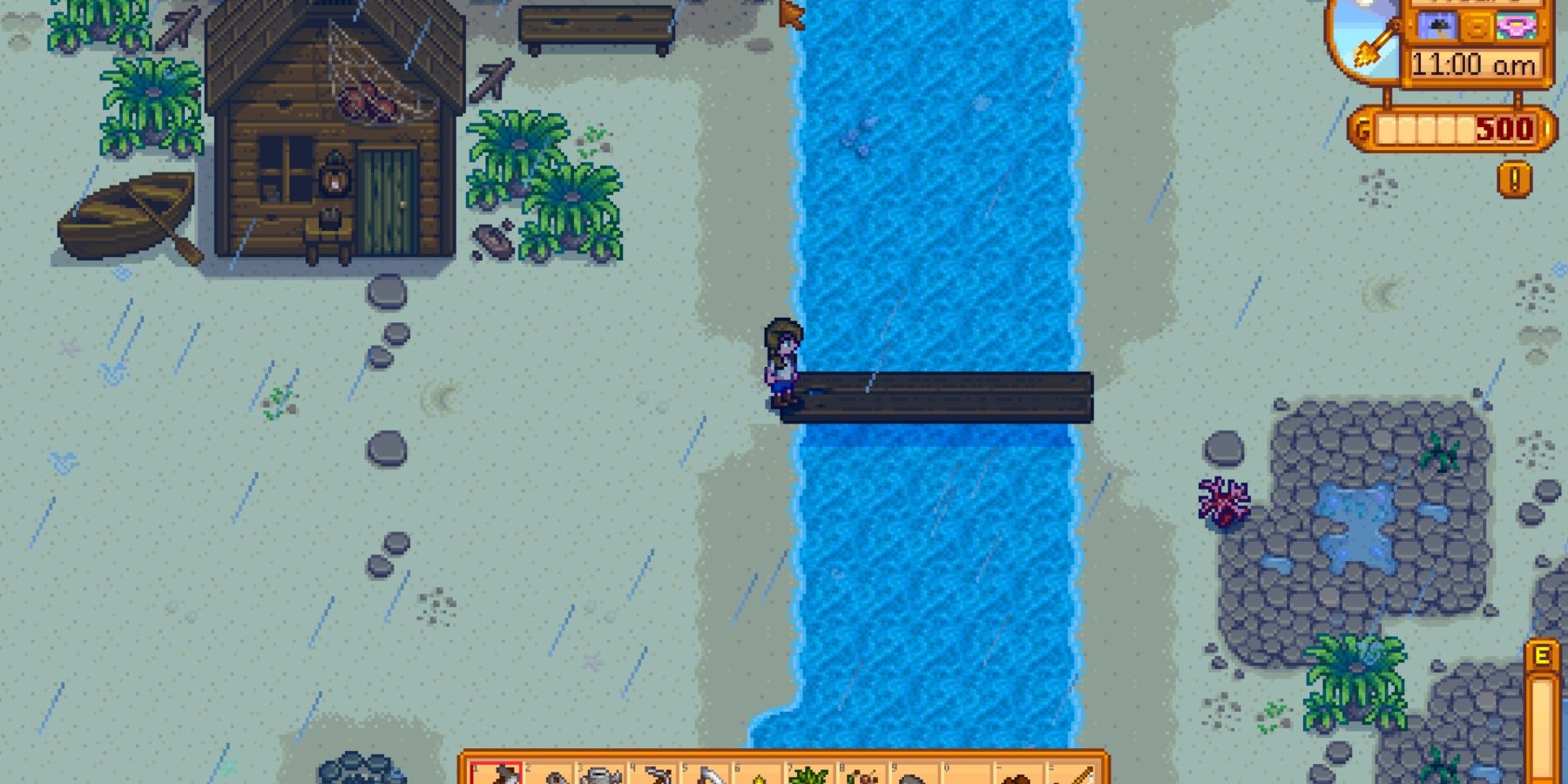 The player standing on the fixed beach bridge while it rains in Stardew Valley