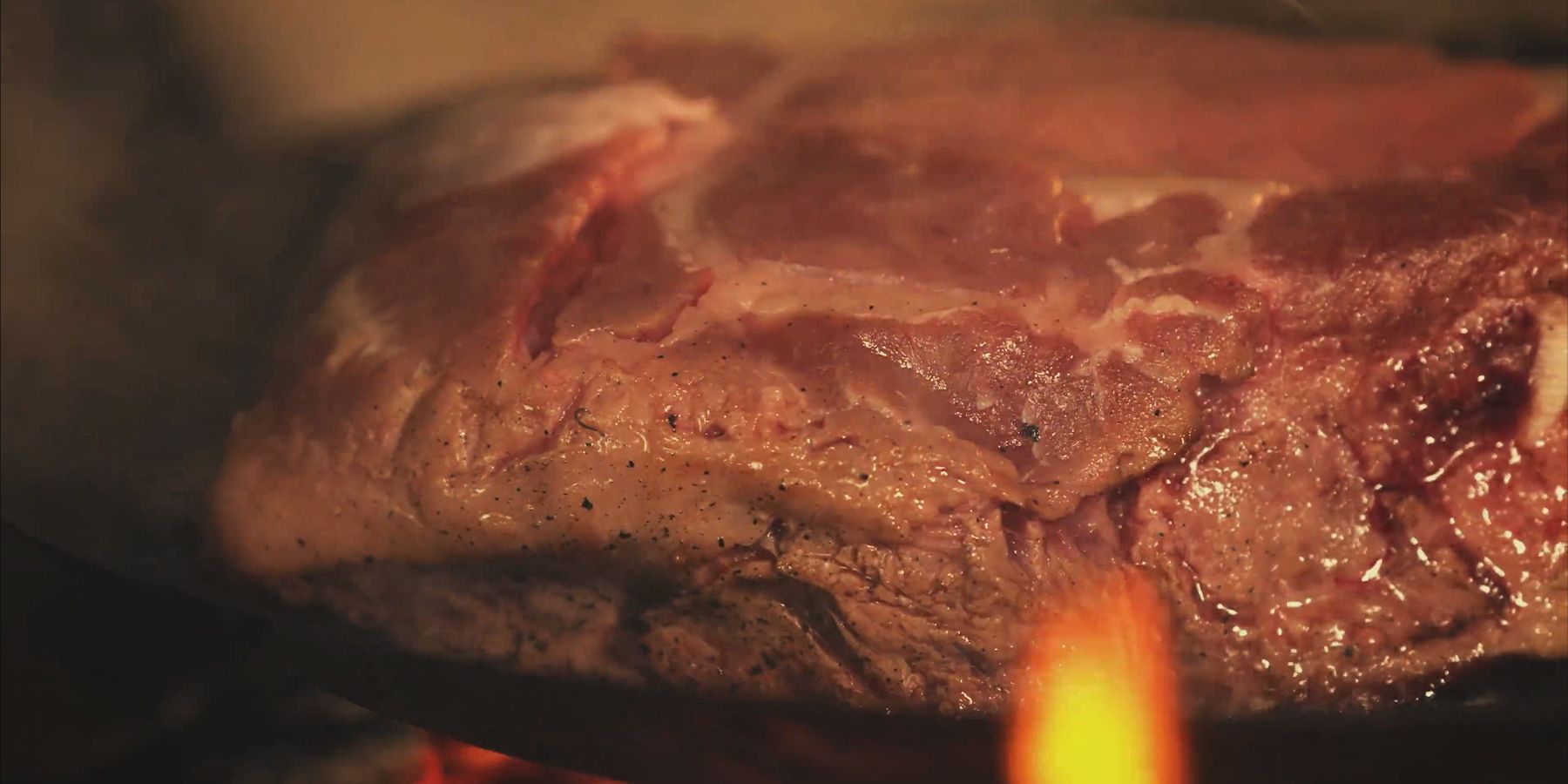 Closeup of fatty meat cooking in Dragon's Dogma 2