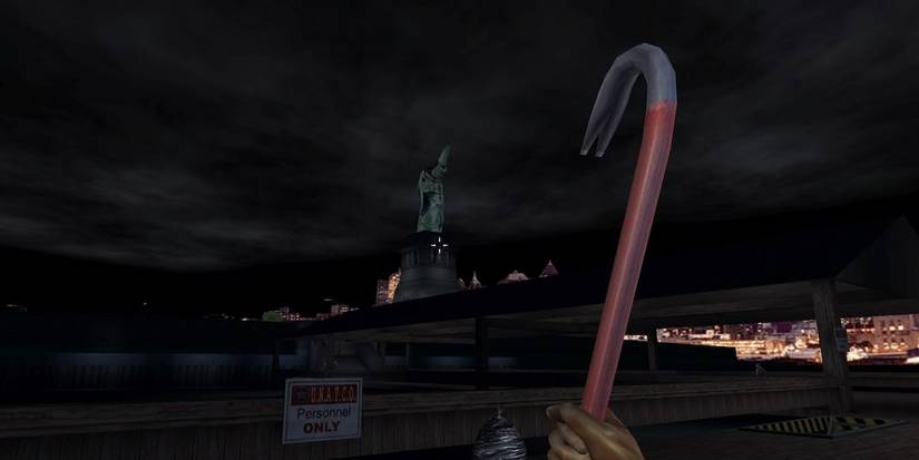 holding a crowbar and looking at the Statue of Liberty