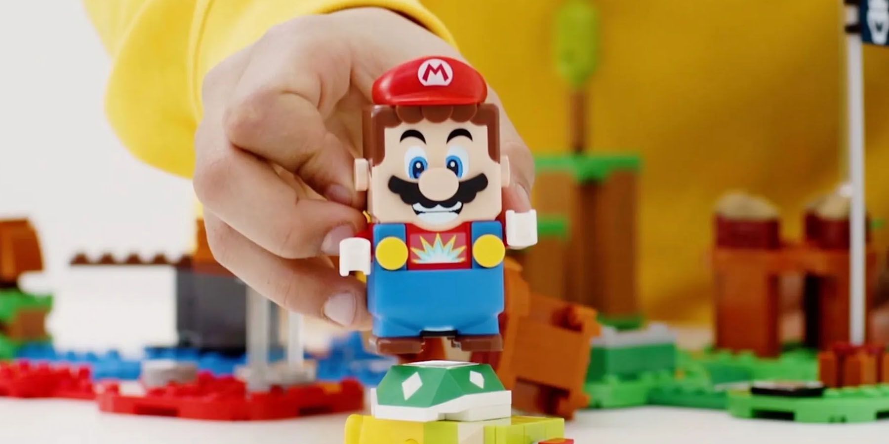 A promotional image of a kid playing with the LEGO Super Mario figure.