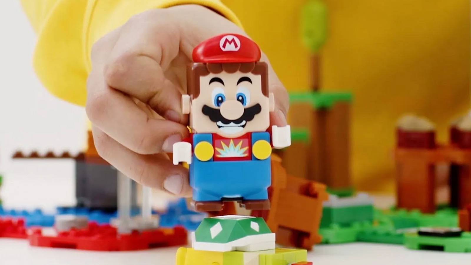 A promotional image of a kid playing with the LEGO Super Mario figure.