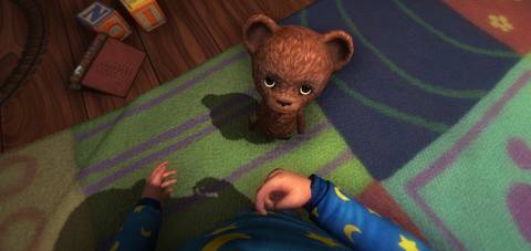 main character of Among The Sleep looking at a teddy bear