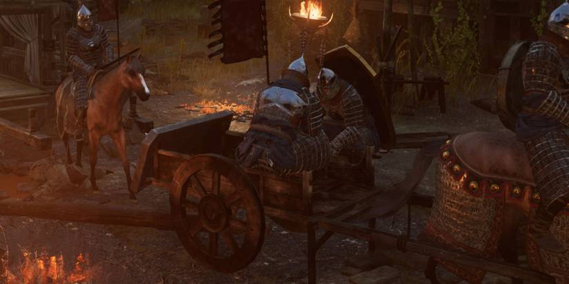 Man in horse and cart with shield on back 