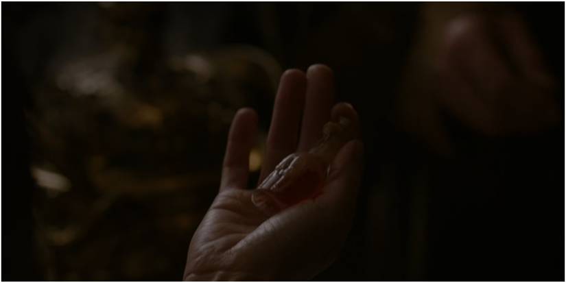 Cersei Lannister holds a vial of Essence of Nightshade in Game of Thrones.