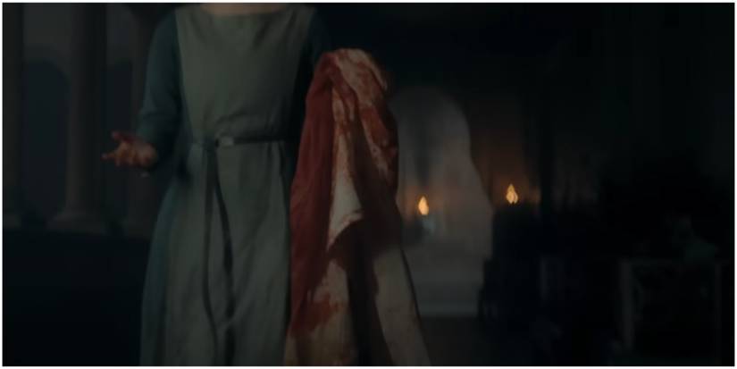 A Red Keep servant holding a bloody cloth in House of the Dragon Season 2 Official Green Trailer.
