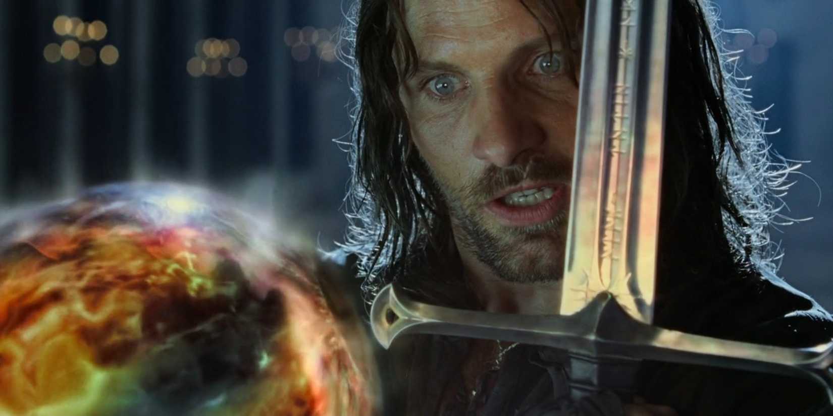 Aragorn holding a sword in front of the palantir