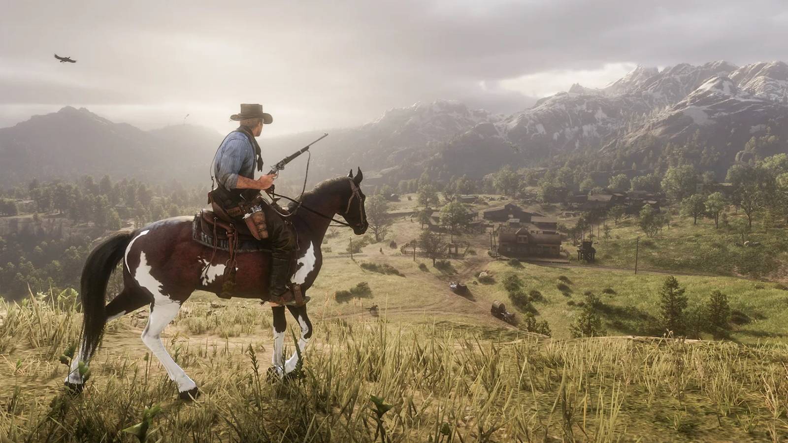 A screenshot of Red Dead Redemption 2 showing Arthur riding atop a hill.