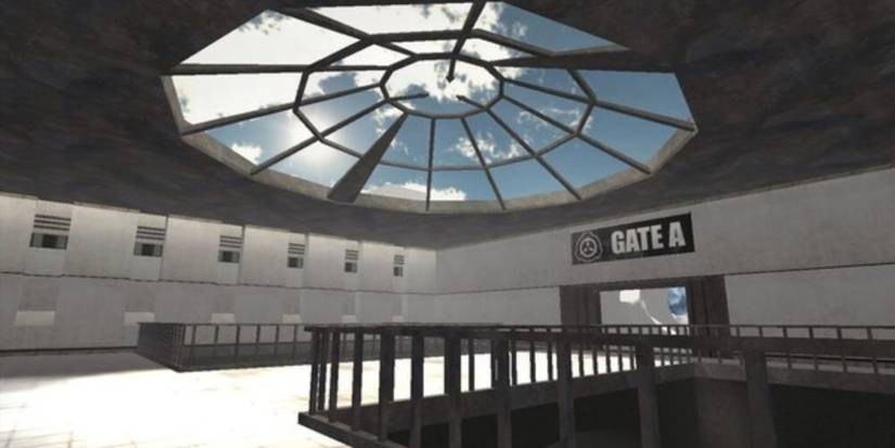 A sterile building with white walls, a large skylight, and a sign saying Gate A on the wall.