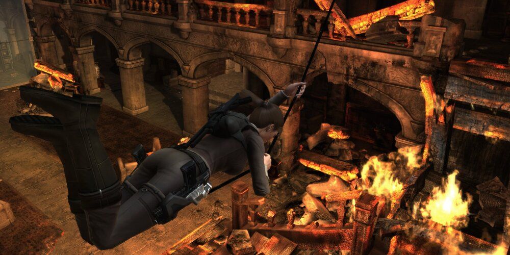 Lara swinging over a pit of fire 