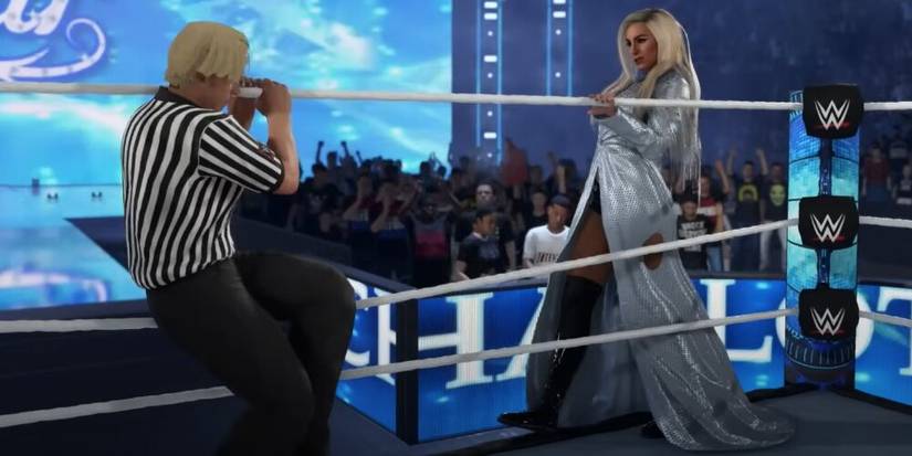 Referee lowering the ropes for Charlotte Flair 