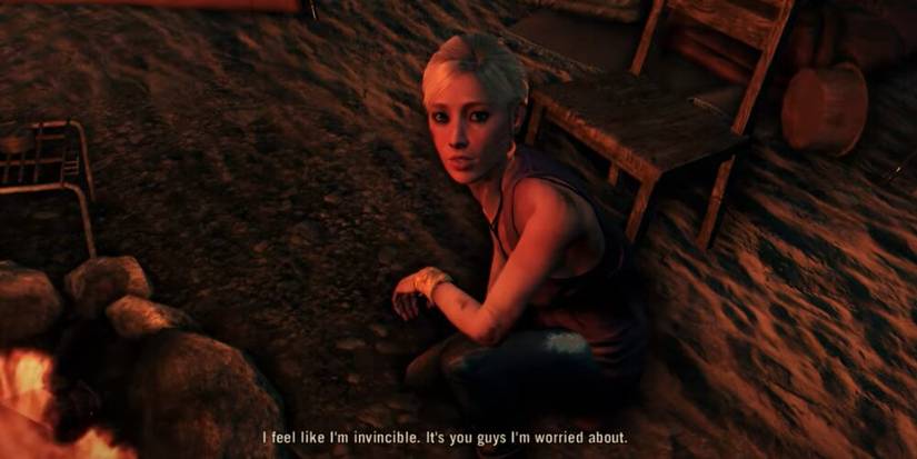 Lisa sitting by a campfire 